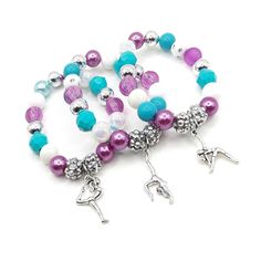 These adorable stretchy bracelets are the perfect favor for your little one's gymnastics themed party! Each bracelet features an antique silver gymnast charm, resin rhinestone beads and an assortment of plum, silver, teal and white 10mm acrylic beads strung with durable stretch floss cord. Each bracelet will arrive individually packaged in an organza bag. Please select the amount of bracelets and the size needed from the drop down menus. Exact shade and bead styles will vary. Bead Styles, Birthday Bracelet, Cardboard Jewelry Boxes, Small Jewelry Box, Stretchy Bracelets, Name Bracelet, Rhinestone Bead, Bead Stringing, Gymnast