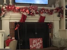 a living room decorated for christmas with stockings and candy canes on the mantel