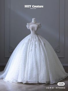 a white wedding dress on display with the words hey couture written above it