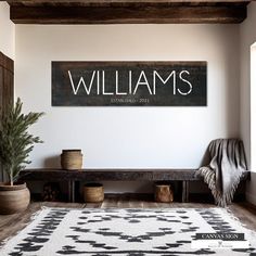 a black and white sign that says williams on the wall next to a wooden bench