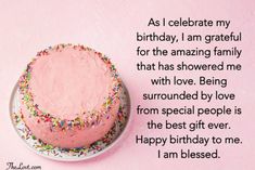 a birthday cake with pink frosting and sprinkles sits on a plate