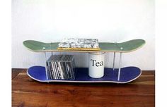 a skateboard shelf with cd's and cds on it