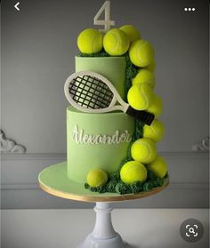 a green cake with tennis balls and a racket on it's top tier