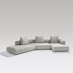 a white couch sitting on top of a gray floor