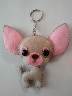 a keychain with a small dog on it's side and eyes open