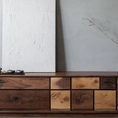 the sideboard is made out of wood and has many drawers on each side,