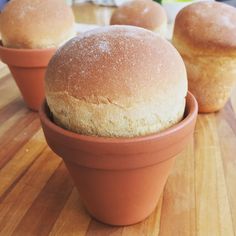 three small bowls with bread in them sitting on a wooden counter top next to each other