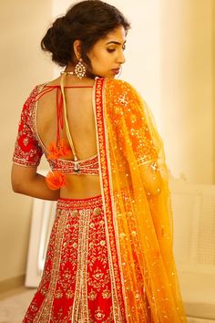 Red blouse with zardozi embroidered floral motifs. Paired with matching kalidar lehenga and sequin dupatta.
Components: 3
Fabric: Raw silk
Neckline: Round
Sleeve Length: Half
Color: Red
Embroidery
Low back with tie up and tassels
Dupatta with embroidered border and tassels
Closure: 
Blouse: Hook back
Lehenga: Side tie up with tassels - Aza Fashions Bollywood Style Red Choli With Mirror Work, Red Dola Silk Sharara With Mirror Work, Red Choli With Zari Work For Navratri, Red Zari Work Choli For Navratri, Designer Kundan Choli In Red, Designer Red Kundan Choli, Red Lehenga With Dori Work For Navratri, Red Lehenga With Mirror Work And Traditional Drape, Red Choli For Navratri With Kundan Style