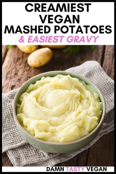 a bowl filled with mashed potatoes on top of a wooden table