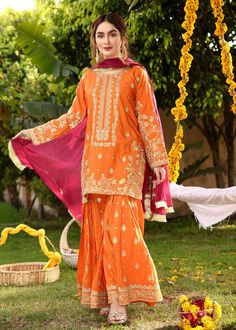 Description Shirt : Orange raw-silk shirt with Embroidery. Trouser : Orange raw-silk Gharara with Embroidery. Dupatta : Reddish maroon chiffon dupatta. Festive Long Sleeve Chinon Sharara, Festive Sharara With Naqshi In Raw Silk, Festive Sharara With Naqshi In Traditional Drape, Festive Raw Silk Sharara With Naqshi Details, Festive Chanderi Sharara With Naqshi Detail, Festive Raw Silk Sharara With Naqshi, Festive Sharara With Embroidery In Raw Silk, Festive Naqshi Traditional Sharara, Festive Naqshi Sharara