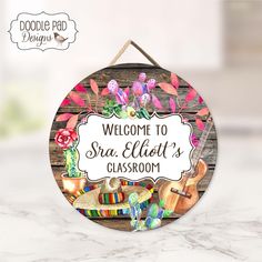 a welcome sign is hanging on a wooden board with colorful flowers and other items around it