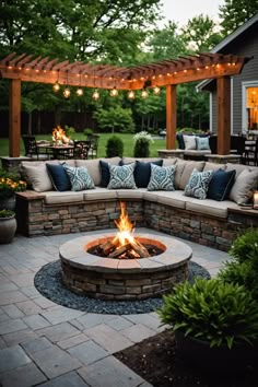 a fire pit surrounded by patio furniture and lights