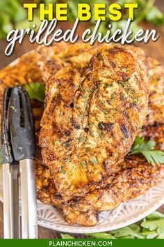 the best grilled chicken recipe on a plate with tongs and garnish