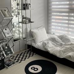 a bedroom with a bed, mirror and black and white checkerboard flooring