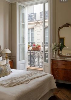 a bed sitting next to a window in a bedroom