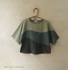 a green and blue shirt hanging on a wall