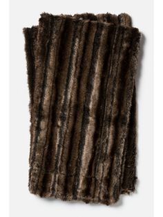 a brown and black fur rug on a white background