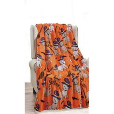 an orange and black halloween themed blanket on a chair