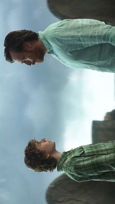 two young men looking at each other in the sky