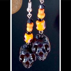 Ready For Halloween, These Handmade Earrings Feature Black Ceramic Skulls With Orange Ceramic Evil Eye Cylinder Beads, Accented By Orange And Glass Seed Beads. Length From Tops Of Silver Tone Hooks 2.8". Halloween Beaded Black Jewelry, Black Beaded Jewelry For Halloween, Spooky Orange Halloween Jewelry, Handmade Skull Earrings For Halloween, Handmade Spooky Black Earrings, Handmade Black Skull Earrings, Handmade Black Halloween Earrings, Black Skull Print Earrings As Gift, Black Skull-shaped Earrings With Skull Print