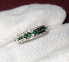 Stunning Emerald Princess Cut Simulated Emerald Engagement & Anniversary Ring - 14K White Gold Finish over 925 Sterling Silver Elevate your love story with this captivating Emerald Princess Cut Simulated Emerald Ring, a perfect blend of elegance and sophistication. Set in a luxurious 14K white gold finish over sterling silver, this ring features a breathtaking princess cut simulated emerald flanked by a sparkling band of simulated diamonds. ✨ Key Features: Exquisite Princess Cut Simulated Emeral Luxury Channel Set Emerald Ring For Anniversary, White Gold Emerald Ring For Anniversary, Princess Cut, White Gold Emerald Ring Princess Cut For Anniversary, Princess Cut Emerald Ring In White Gold For Anniversary, White Gold Emerald Cut Jewelry For Anniversary, 14k White Gold Channel Set Jewelry, 14k White Gold Channel Set Rings For Anniversary, May Birthstone Jewelry With Diamond Accents For Anniversary, Formal Emerald Channel Set Jewelry