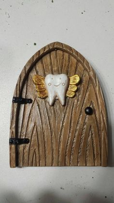 a tooth shaped door with wings on it