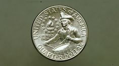 a coin with the image of a man holding a frying pan on it's side