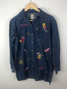 "Vintage Warner Bros. Embroidered Denim Button Front Shirt  Womans Small  Tweety Bird  Measures Approx. armpit to armpit 22 inches  x shoulder to hem 29 inches  in very good pre-owned condition missing a sequin on the \"purse\" on front Any Questions Please Ask" Vintage Long Sleeve Denim Top For Spring, Retro Medium Wash Tops For Spring, Retro Denim Blue Tops For Spring, Vintage Button-up Denim Top For Spring, Trendy Embroidered Denim Tops, Retro Long Sleeve Denim Top, Retro Button-up Denim Top, Embroidered Long Sleeve Denim Top, Spring Vintage Button-up Denim Top