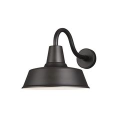 an outdoor wall light with a black shade on the side and a white light behind it