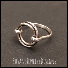 This ring is made with a sterling silver open circle that has a really neat design that twists as it goes around. Sterling silver wire has been added to make up the band of the ring. This ring is super comfortable to wear. Use the options pull down menu to select your ring size. Comes wrapped and ready to gift if needed. To see my other rings, click here: https://www.etsy.com/shop/SusansJewelryDesigns?ref=seller-platform-mcnav&section_id=7658693 Open Circle Ring, Saddle Ring, Circle Jewelry, Circle Ring, Custom Ring, Jewelry Sterling Silver, Initial Jewelry, Ring Sterling Silver, Pearl Ring