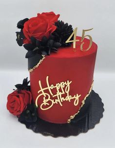 a red and black birthday cake with flowers on it's side, the number forty five