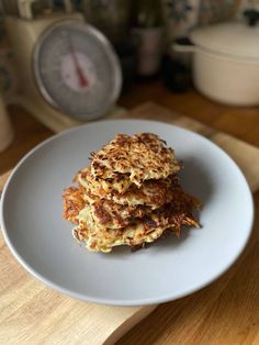 a stack of pancakes sitting on top of a white plate next to a thermometer