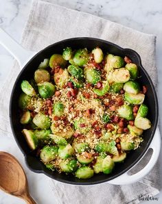 brussel sprouts with bacon and parmesan cheese in a skillet