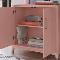 a pink bookcase with books on top of it