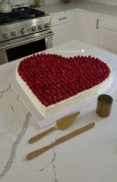 a heart shaped cake with raspberries on it