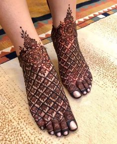 the feet are decorated with henna designs