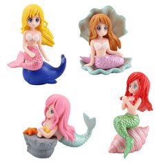 four little mermaid figurines sitting on top of each other