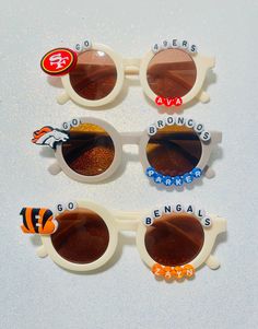 Welcome! we offer personalized NFL team sunglasses for Kids! please add the name and the Team you would like or any other additional request down below in Personalization.  THANK YOU!! **note** Children should not put the sunglasses in their mouths or play with them unattended.  Small parts can come loose and be a choking hazard. Always supervise and monitor young children while they are wearing our custom sunglasses to ensure that they are being used safely and appropriately. Customizable White Adjustable Sunglasses, Trendy White Sunglasses With Custom Name, Customizable Fun Plastic Sunglasses, Team Sunglasses, Sunglasses For Kids, Personalized Sunglasses, Custom Sunglasses, Castle Rock, Kids Sunglasses