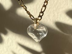 Beautiful puffy glass heart necklace on a gold plated stainless steel Figaro chain. Typically made to 14-4.5" but let me know if you would like it in a different length! Vintage Glass Heart Necklace, Glass Necklaces With Gold Chain For Gift, Everyday Gold Glass Jewelry, Everyday Gold Glass Necklaces, Gold Glass Wedding Jewelry, Elegant Glass Heart Charm Necklace, Vintage Clear Necklace For Gift, Clear Glass Heart-shaped Jewelry, Clear Glass Necklaces For Wedding