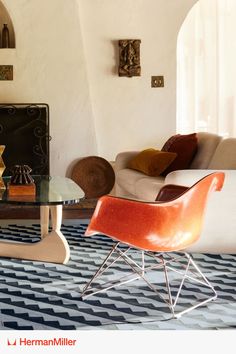 a living room filled with furniture and a fire place in the middle of the room