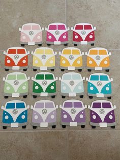 a group of colorful vw buses sitting on top of a tiled floor