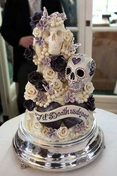 there is a cake decorated with skulls and flowers