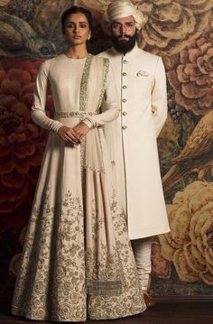 Ivory Color Wedding Gown – Panache Haute Couture Beige Anarkali Wedding Gown, Beige Anarkali Dress For Wedding, Elegant Raw Silk Sherwani For Reception, Formal Anarkali Raw Silk Gown, Formal Anarkali Gown In Raw Silk, Elegant Floor-length Sherwani With Intricate Embroidery, Formal Raw Silk Gown With Zari Work, Silk Sherwani With Zari Work For Wedding, Luxury Silk Wedding Gown