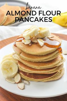 a stack of pancakes topped with bananas and syrup