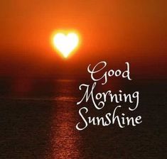 the sun is setting over the ocean and it says, good morning sunshine with a heart