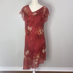 Vintage Alyn Paige Dress. Rust Floral With Cowl Neckline And Asymmetrical Hem. Fully Lined. Flowy Sleeves. Very Lightweight. Does Have A Small Tag Hole On The Back Of Neck. Pictured Above. Tag Says 13/14 But Fits Smaller. B5 Measured Flat Pit2pit 18” Length Shortest 37” Length Longest 45” Colors May Slightly Vary Due To Lighting Or Viewers Monitor. Measurements Are Approximate Spring Dresses With Asymmetrical Neckline And Flowy Fit, Flowy Dresses With Asymmetrical Neckline For Spring, Red Knee-length Asymmetrical Dress For Spring, Flowy Dress With Asymmetrical Neckline, Flowy Summer Dress With Asymmetrical Neckline, Casual Chiffon Dress With Asymmetrical Hem, Red Asymmetrical Neckline Summer Dress, Elegant Red Asymmetrical Summer Dress, White Floral Print Dress