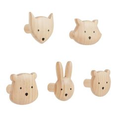 four wooden animal heads are shown in the shape of rabbits, bears and cats on white background