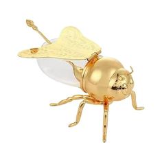 a golden bee figurine with writing on it