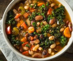 a white bowl filled with bean and vegetable soup