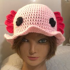 a mannequin head wearing a pink crocheted hat